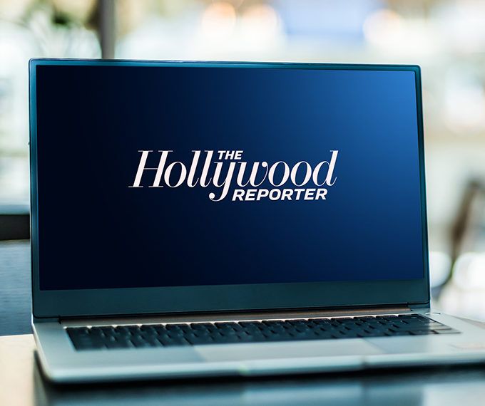 Laptop on desk displaying The Hollywood Reporter logo
