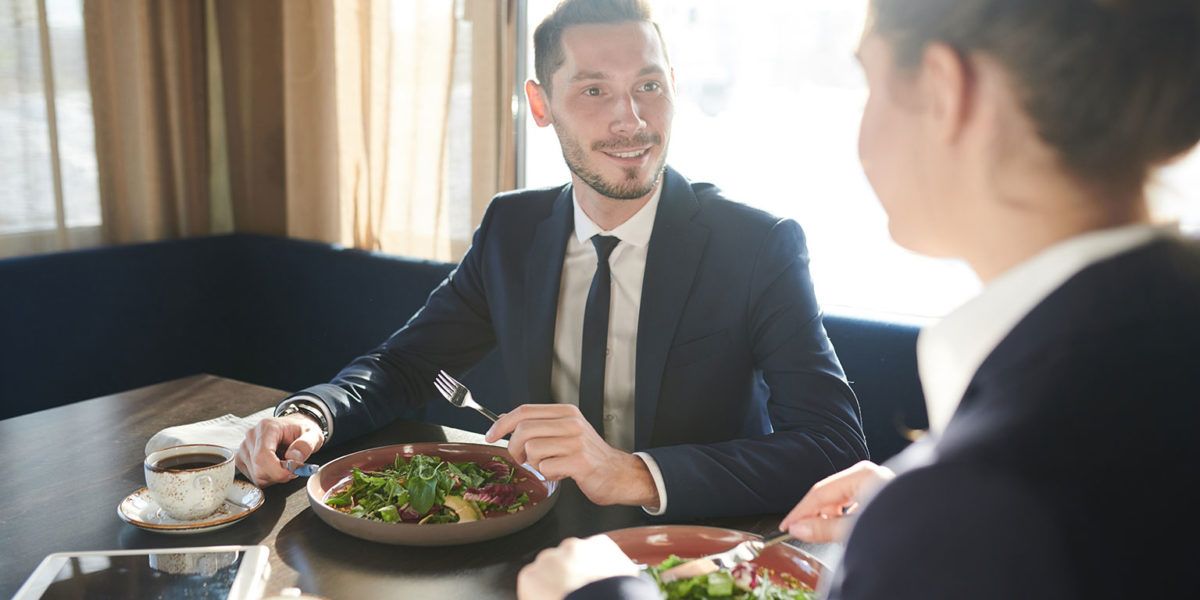 Colleagues discuss business over lunch