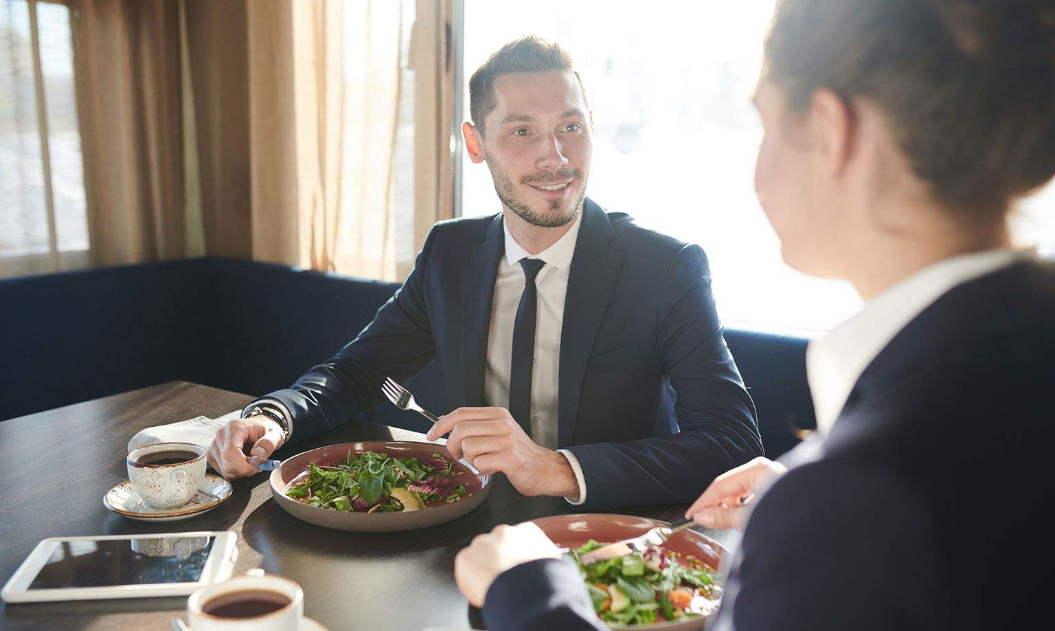 Colleagues discuss business over lunch