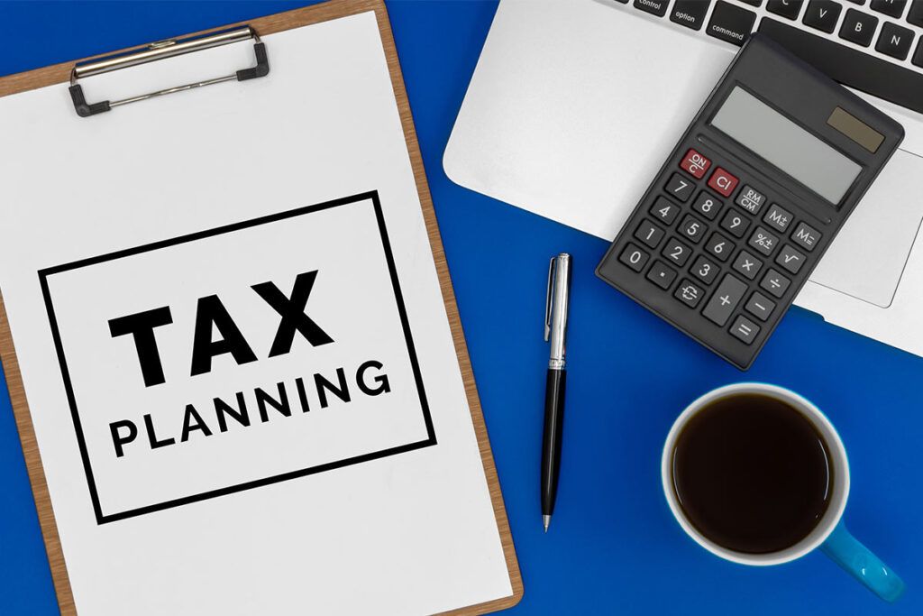 tax planning clipboard with coffee cup and calculator