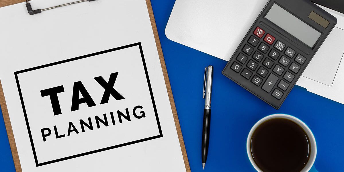 tax planning clipboard with coffee cup and calculator