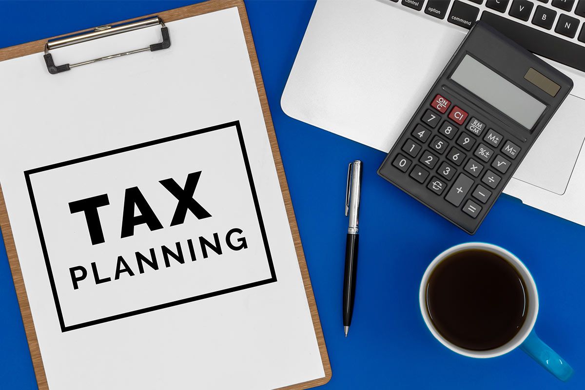 tax planning clipboard with coffee cup and calculator