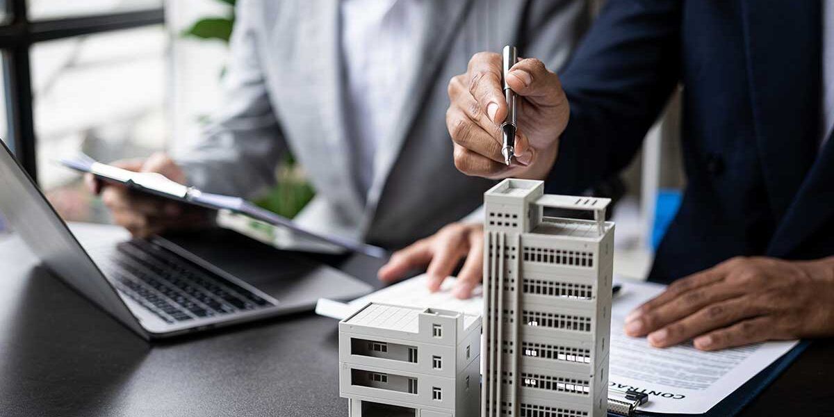 two business people looking over a building model