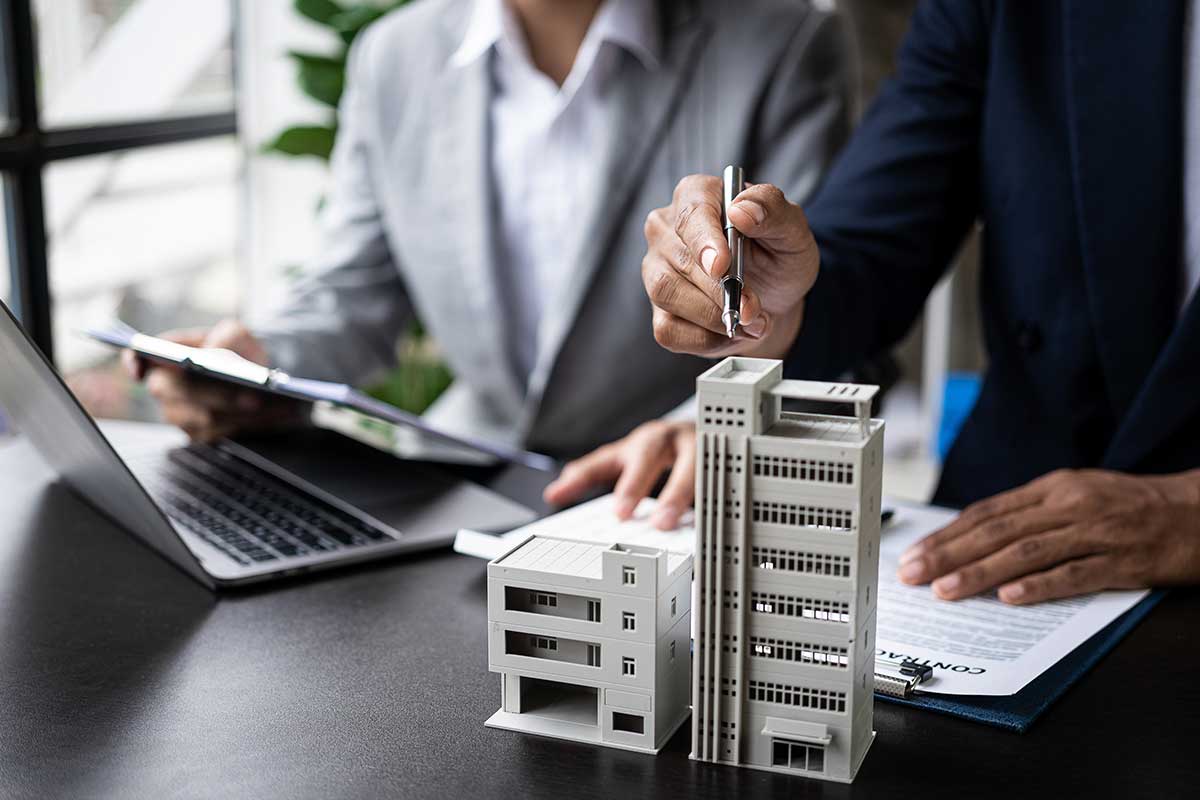 two business people looking over a building model