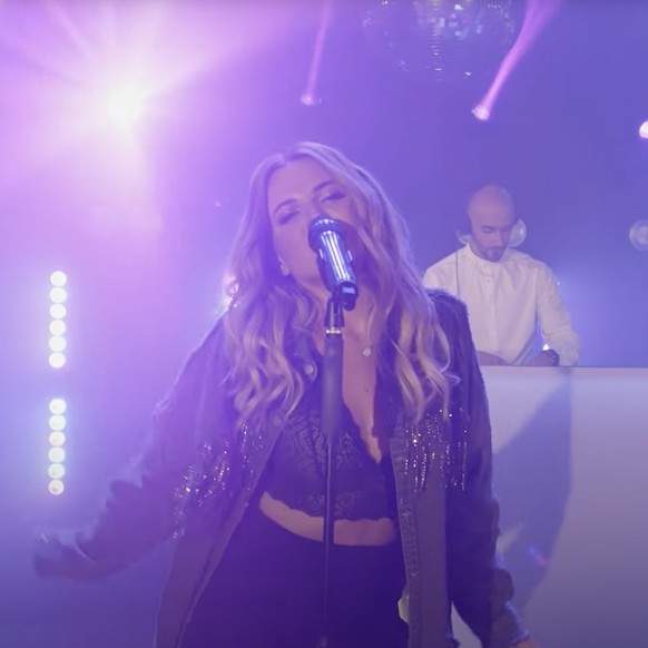 A female vocalist performing on stage