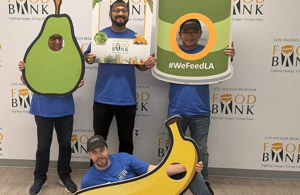 Volunteering at the Los Angeles Regional Food bank and posing with props - thumbnail