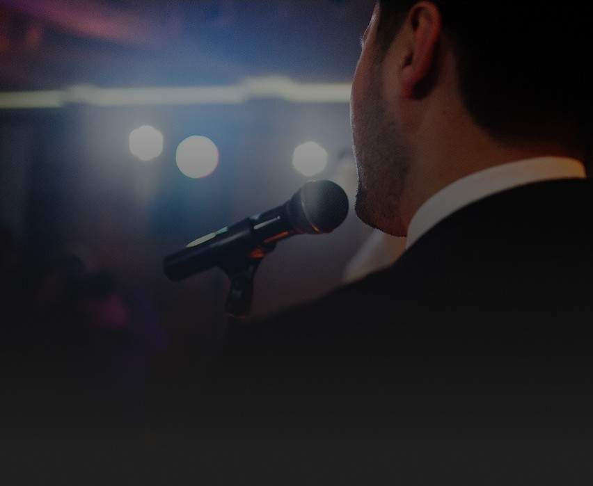 A male vocalist performing on stage