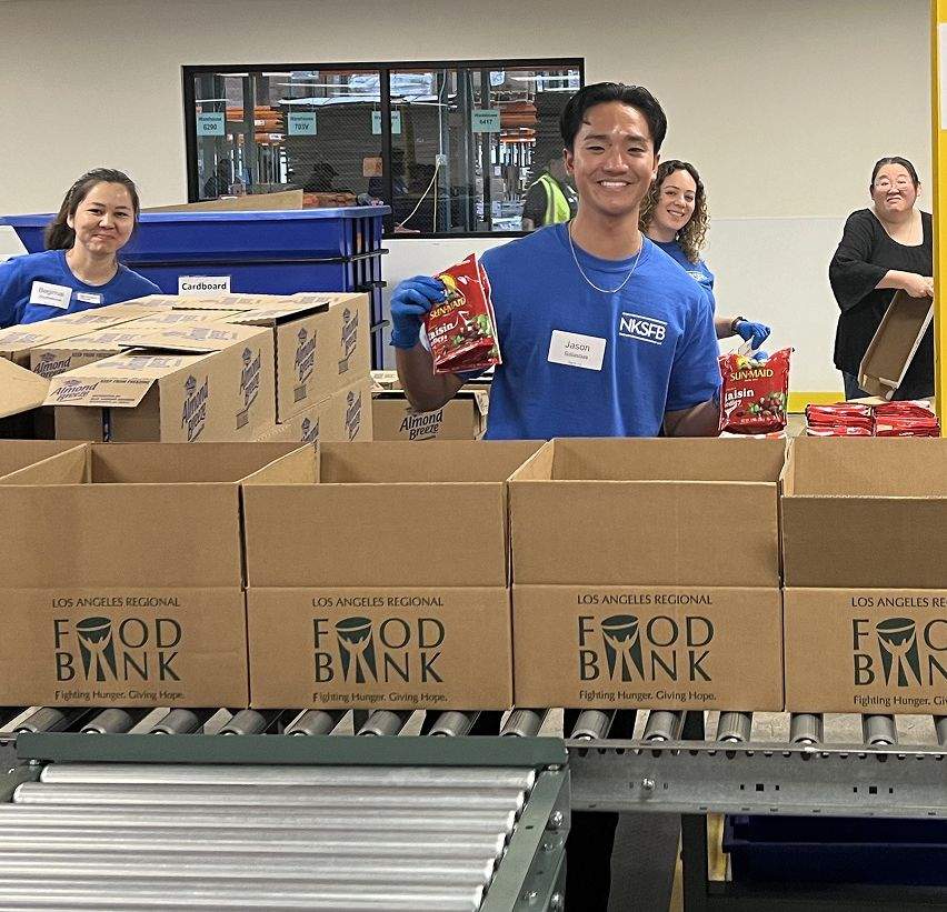 The Team fights hunger by volunteering at the Los Angeles Regional Food Bank.
