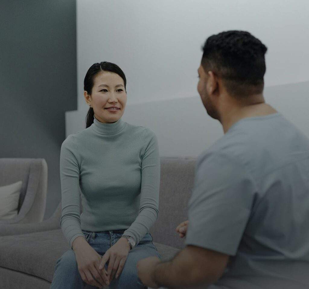 A man and woman sitting opposite one another, having a conversation