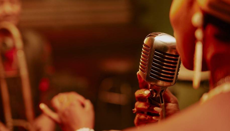 A vocalist singing into a microphone