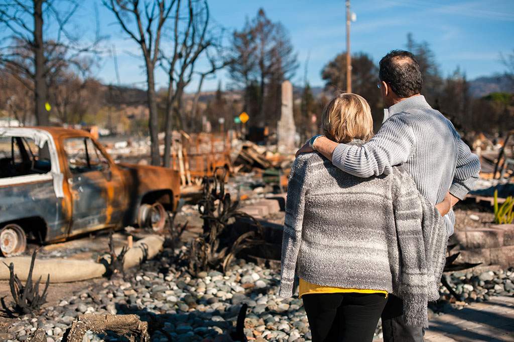 Man and woman looking at a torn down lot